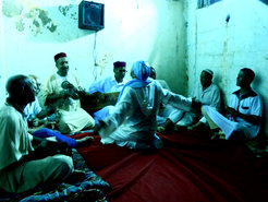 Figure 1. Dīwān ritual of the Bilaliyya Order, one of the Sufi orders in Algeria. The young man facing the musicians is being musically worked into a process of trance. 2016, Oran, Algeria.